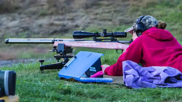 An F-Class shooter prone behind a scoped rifle on a rest