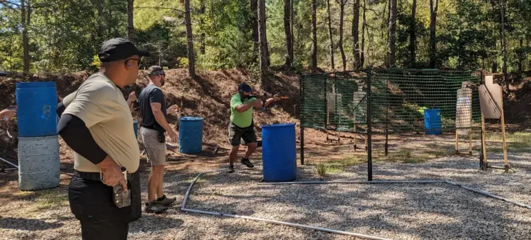 A pistol bay at the club with competitors shooting a stage