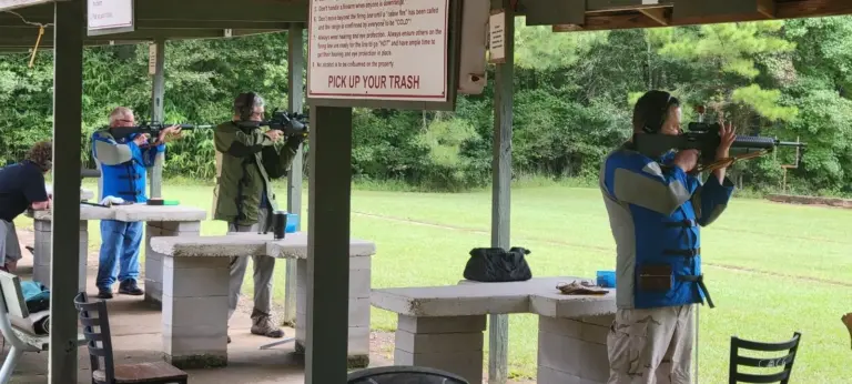 NRA Service Rifle competitors shooting from the covered line
